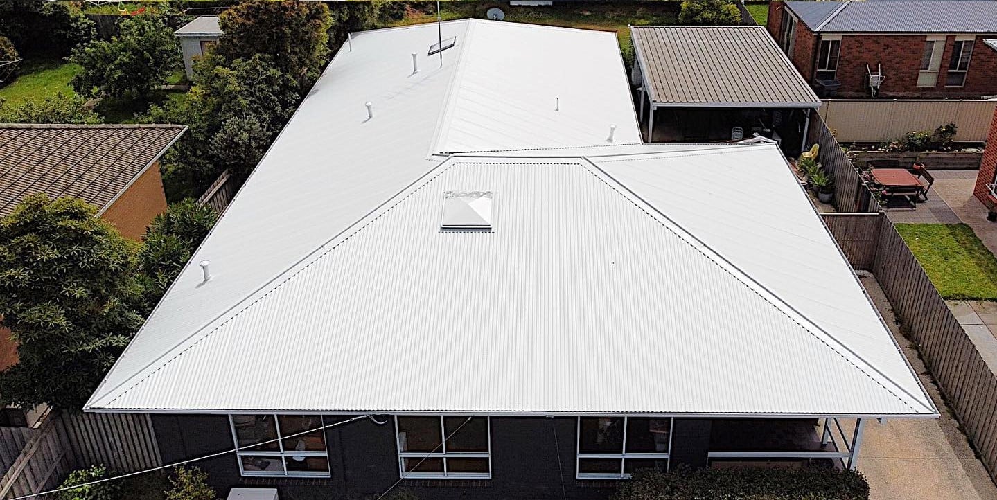 Corrugated metal roof with a light finish after restoration.