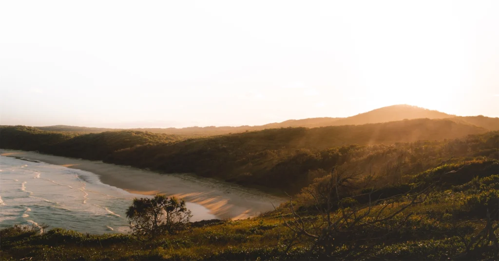 Noosa coastline at sunset in Queensland, representing Australian coastal conditions protected by Industrial Roof Coatings roof coating systems.