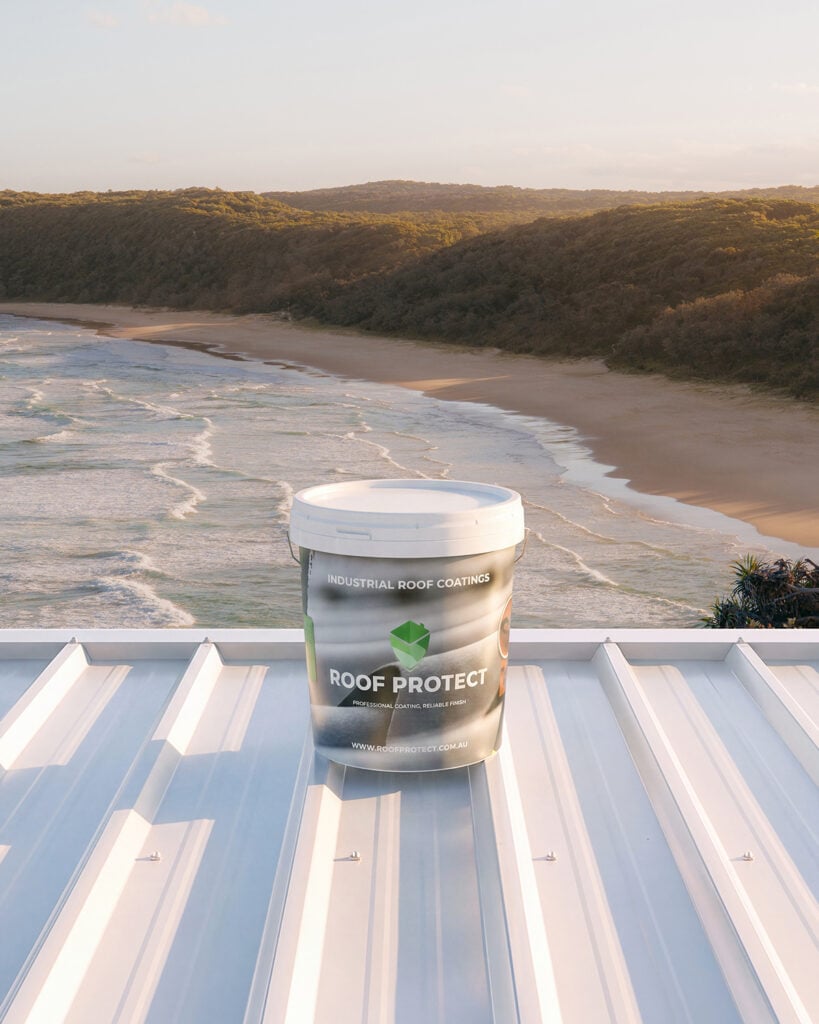 Industrial Roof Coatings Roof Protect 20-year premium roof coating on a white metal roof beside the Australian coast.