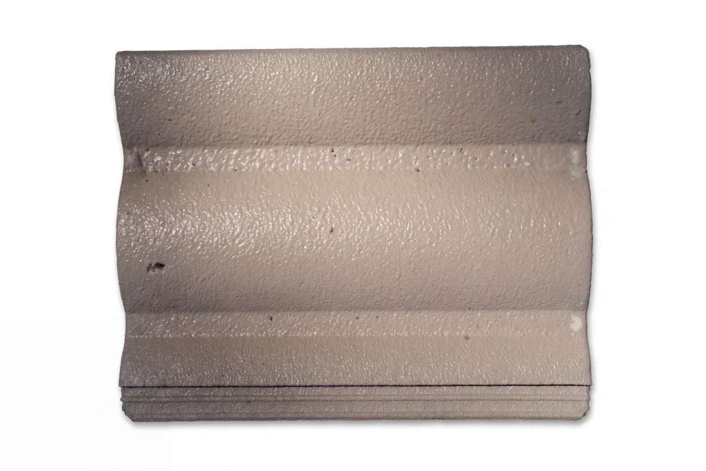 Front profile of a Boral Macquarie concrete roof tile showing its curved channels and textured surface.